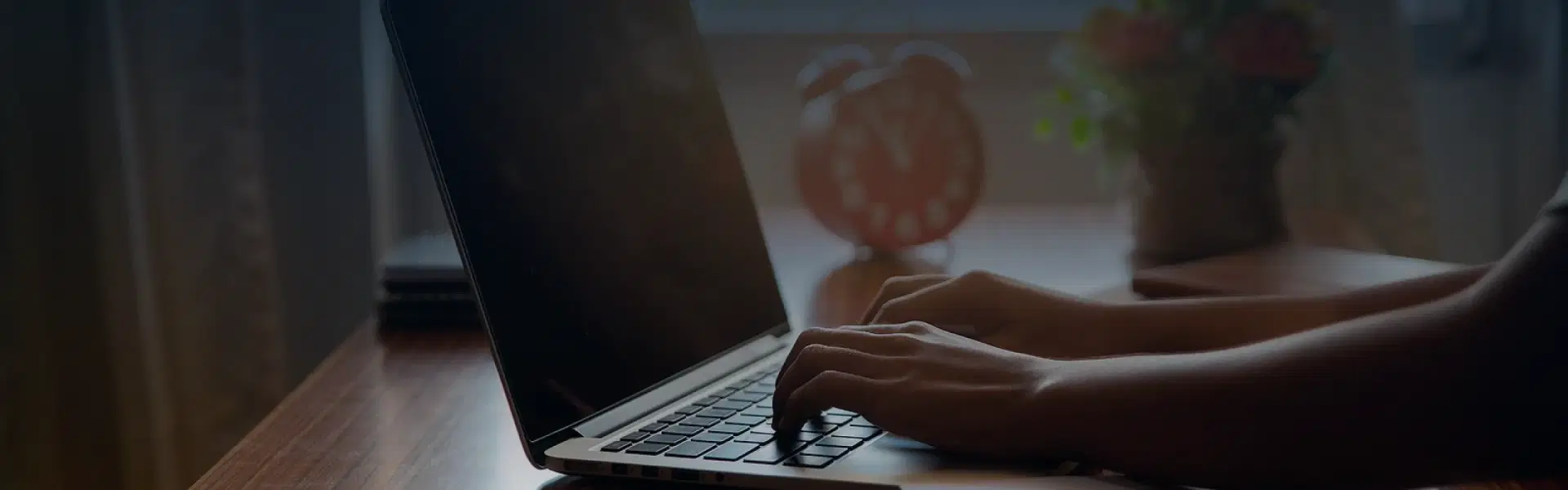 Hands typing on a laptop.